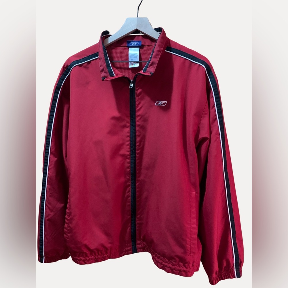 REEBOK JACKET
Red and black zip lined windbreaker.

SIZE M